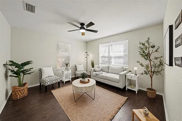 a living room with furniture potted plant and a window