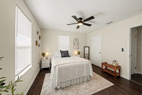 a bedroom with a bed and wooden floor