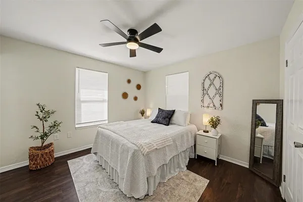 a bedroom with a bed and a chandelier