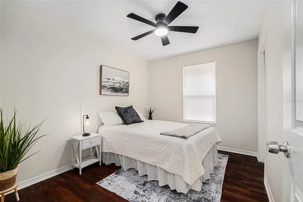 a bedroom with a large bed and a window