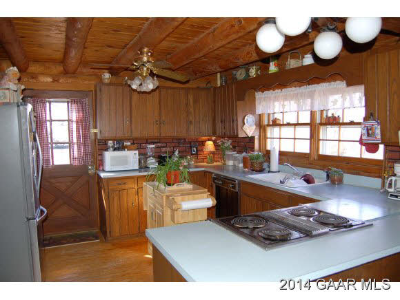 844 Barnhart Road Fort Defiance, VA 24437 - Photo 3 of 25 a open kitchen with stainless steel appliances granite countertop a stove a sink dishwasher and couches with wooden floor