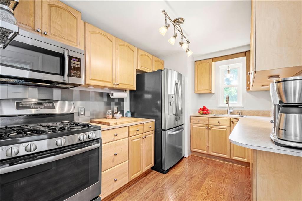 243 Castle Road Pittsburgh, PA 15234 - Photo 7 of 22 Stainless steel appliances and backsplash
