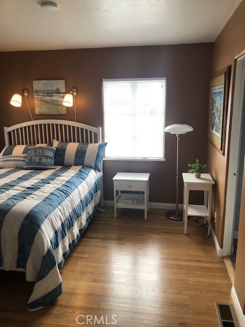 640 Cuprien Way Laguna Beach, CA 92651 - Photo 12 of 18 a spacious bedroom with a bed and a table in it