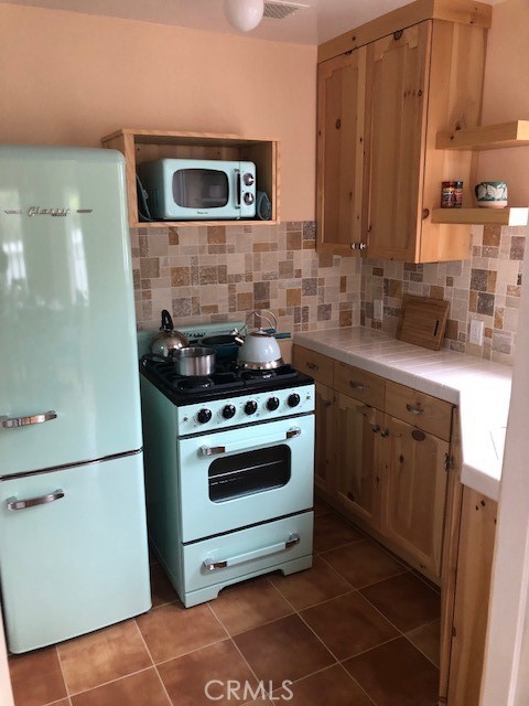 640 Cuprien Way Laguna Beach, CA 92651 - Photo 7 of 18 a kitchen with a stove and a microwave