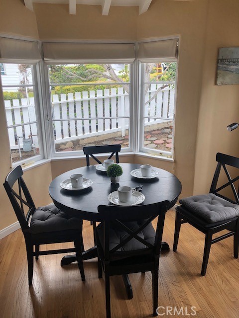 640 Cuprien Way Laguna Beach, CA 92651 - Photo 9 of 18 a view of a dining room with furniture and wooden floor