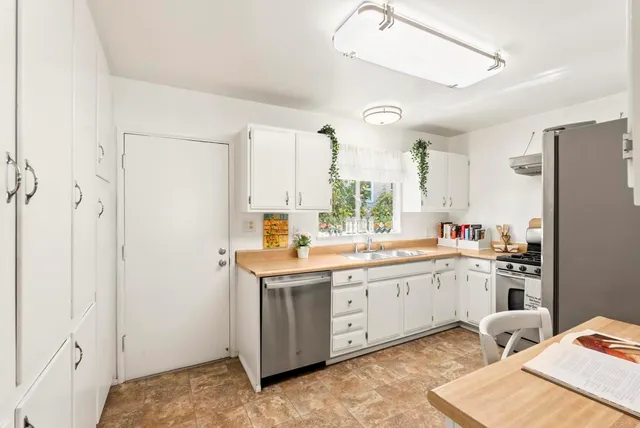 a kitchen with a sink appliances and cabinets