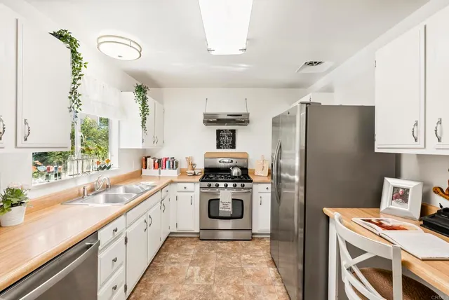 a kitchen with a sink stainless steel appliances and cabinets