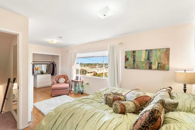 a bedroom with a large bed and a couch