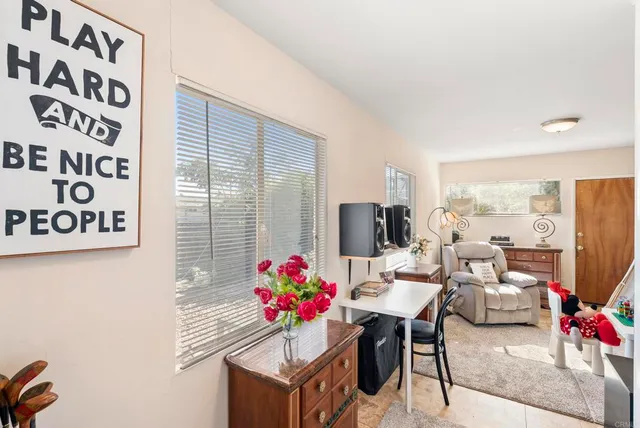 a living room with furniture and a potted plant