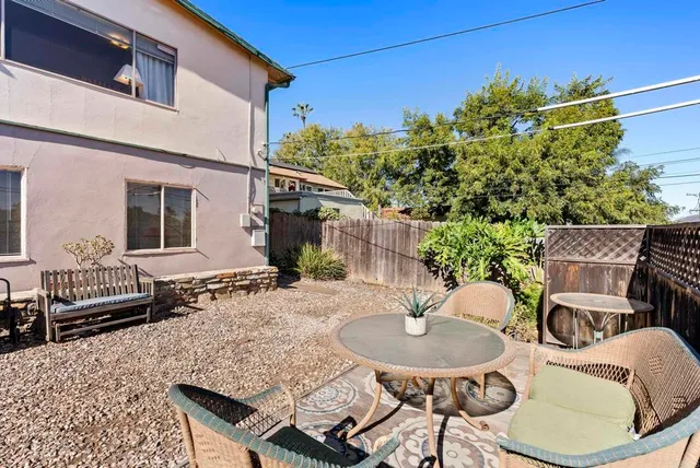 a backyard of a house with yard fire pit and furniture