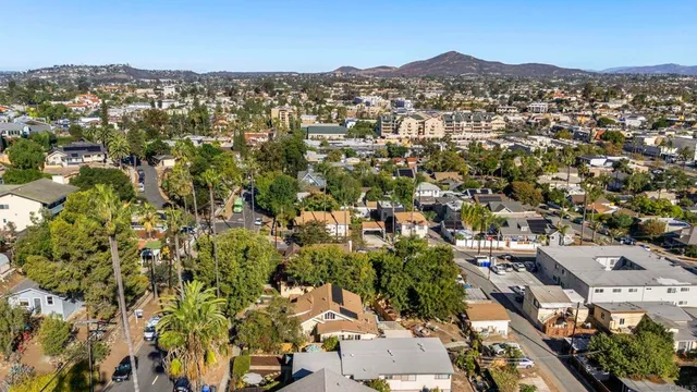 an aerial view of residential houses with city view