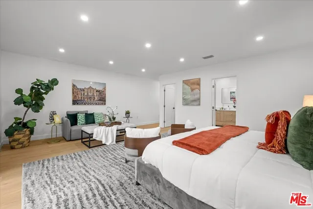 a bedroom with a bed and a couch