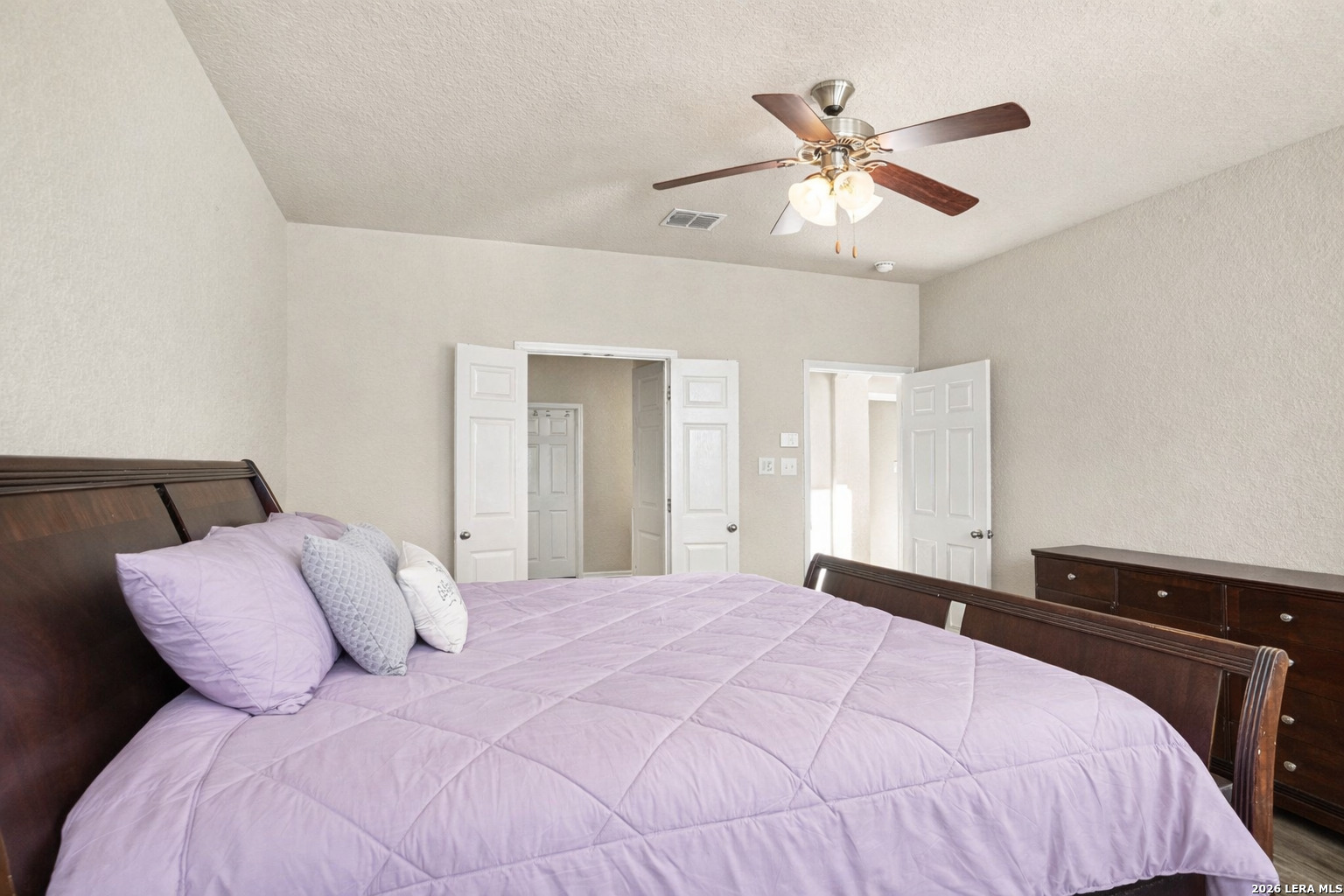 213 Wildcat Cibolo, TX 78108 - Photo 16 of 35 a bedroom with a large bed and a ceiling fan