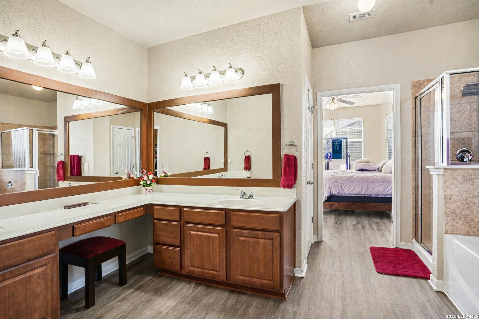 213 Wildcat Cibolo, TX 78108 - Photo 18 of 35 a spacious en suite bathroom with a granite countertop double vanity and a large mirror