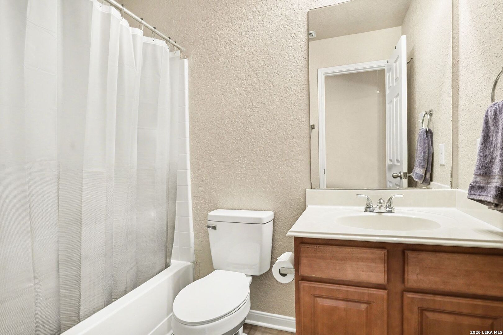 213 Wildcat Cibolo, TX 78108 - Photo 24 of 35 a bathroom with a sink a toilet and shower curtain