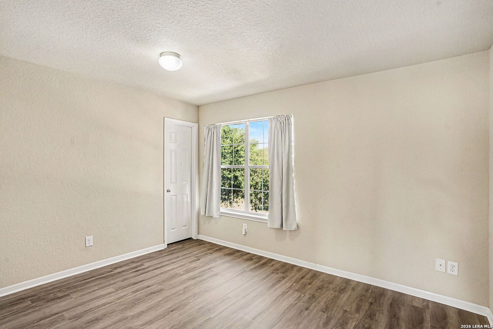 213 Wildcat Cibolo, TX 78108 - Photo 27 of 35 an empty room with wooden floor and windows