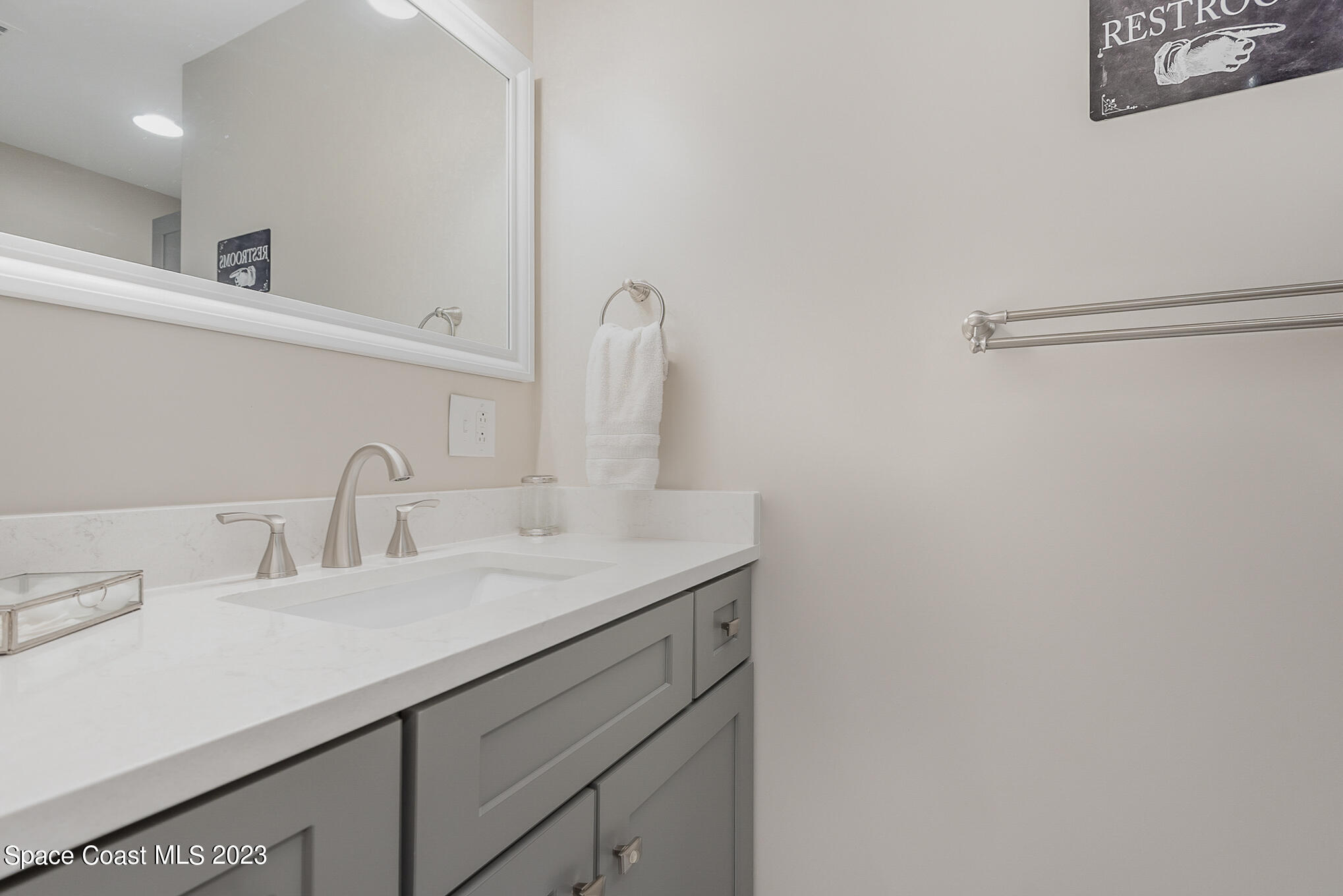 925 Trinidad Road Cocoa Beach, FL 32931 - Photo 23 of 32 a bathroom with a sink and a mirror