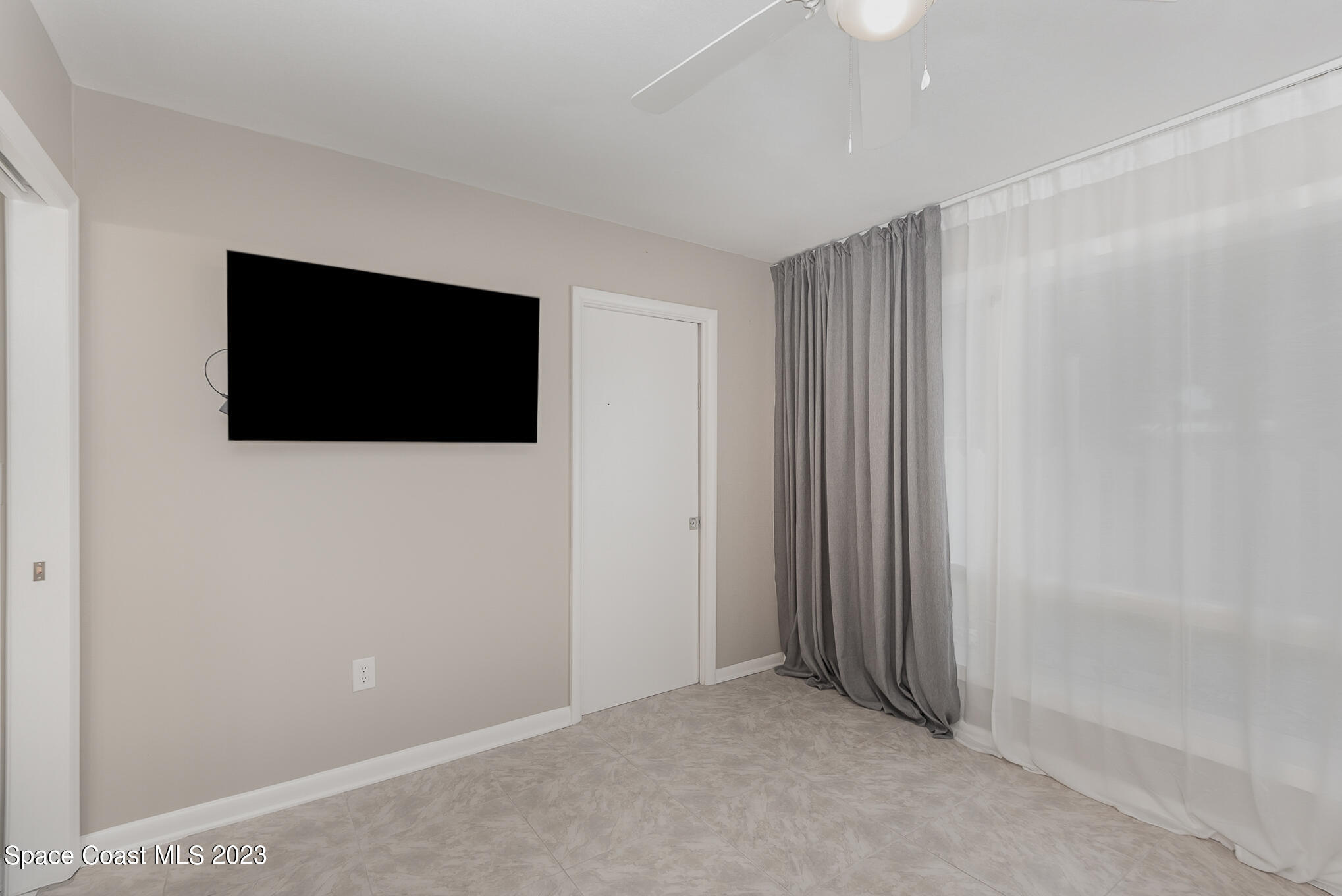 925 Trinidad Road Cocoa Beach, FL 32931 - Photo 24 of 32 a view of an empty room with a flat screen tv