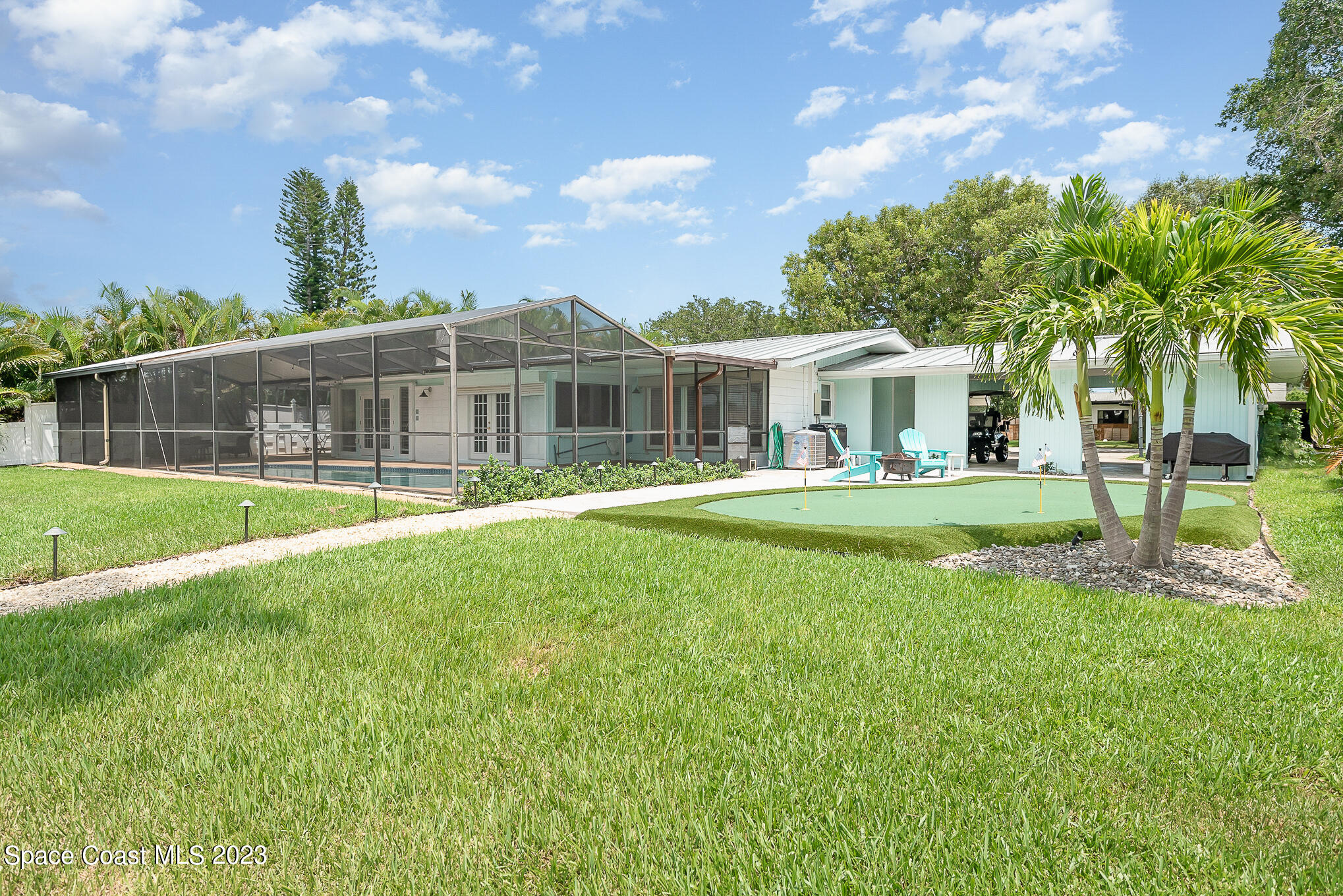 925 Trinidad Road Cocoa Beach, FL 32931 - Photo 26 of 32 a view of a house with a yard patio and a patio