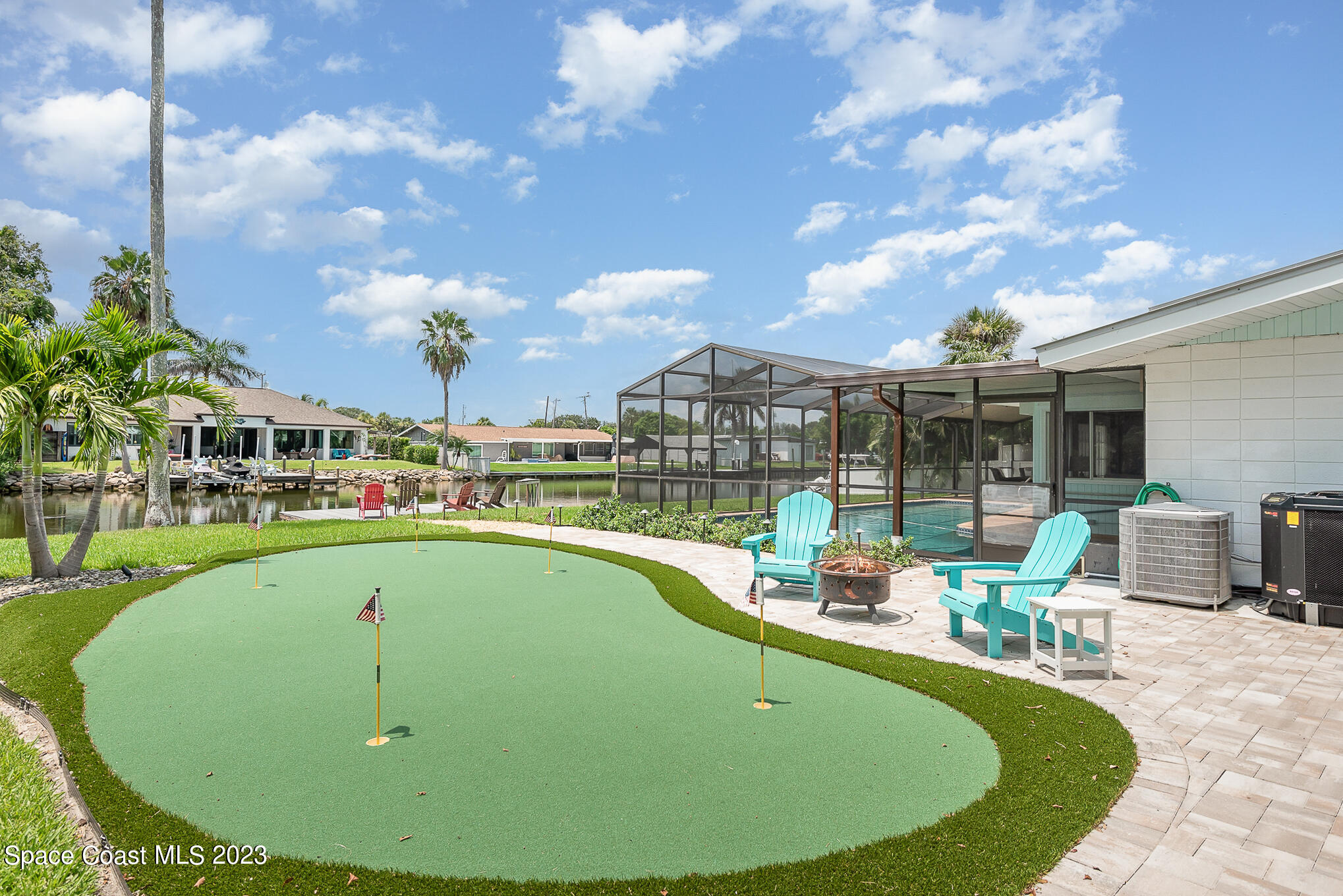 925 Trinidad Road Cocoa Beach, FL 32931 - Photo 5 of 32 a view of a swimming pool with a patio