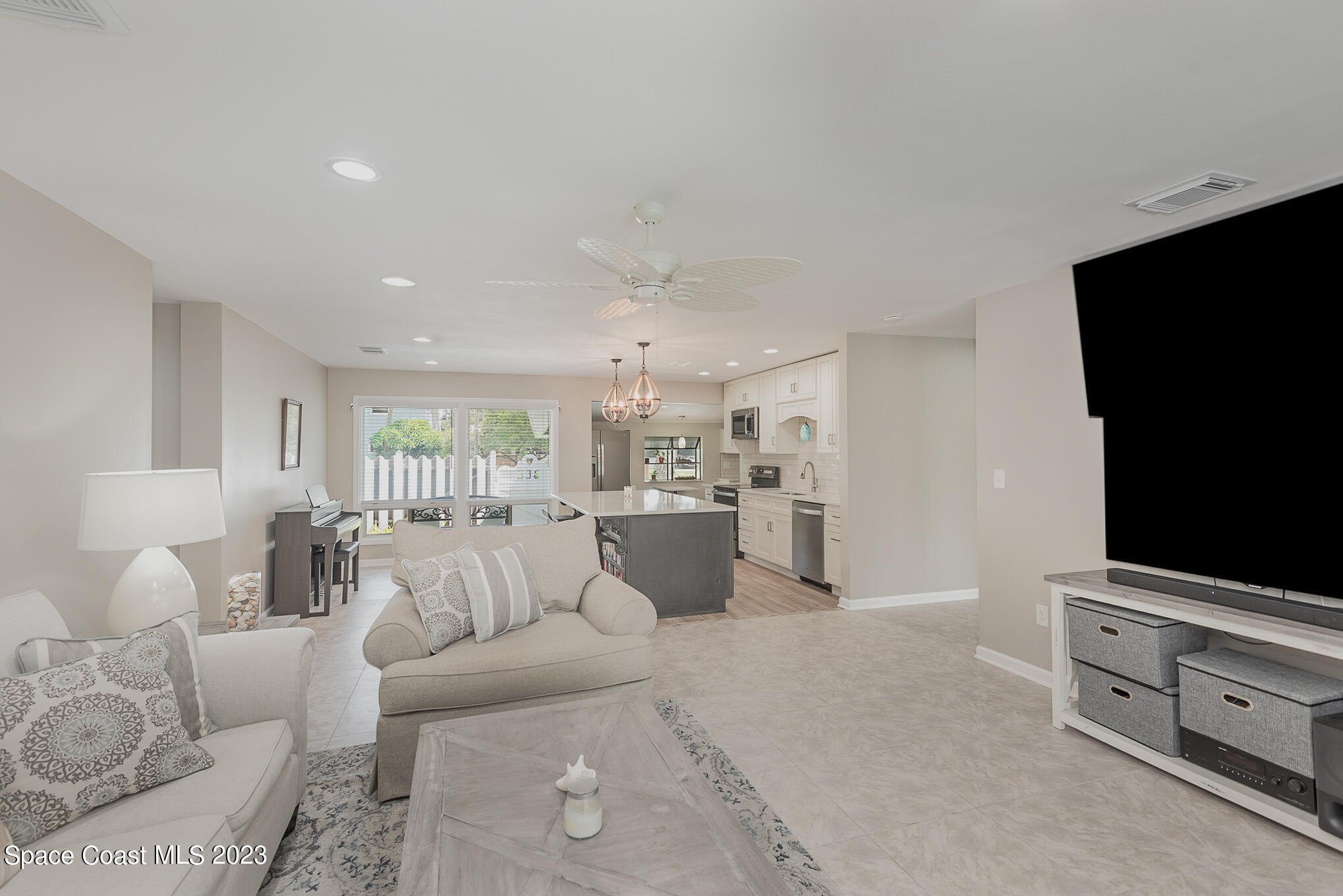 925 Trinidad Road Cocoa Beach, FL 32931 - Photo 6 of 32 a living room with furniture and a flat screen tv