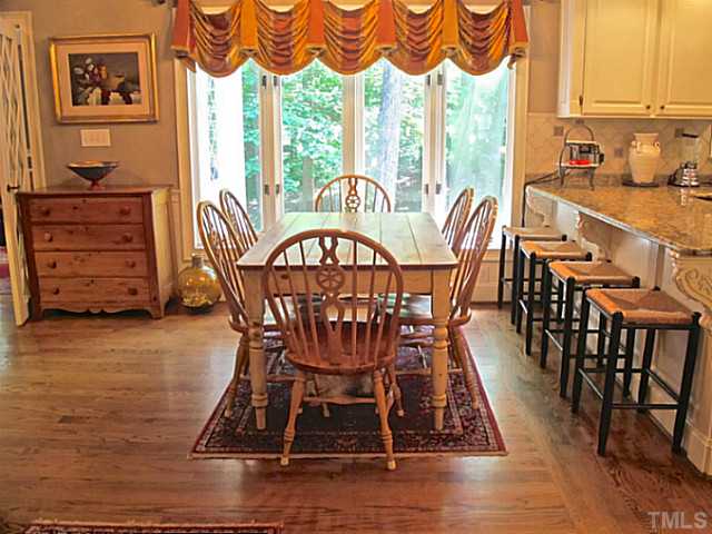 2600 Ridge Road Raleigh, NC 27612 - Photo 8 of 25 a view of a dining room with furniture window and wooden floor
