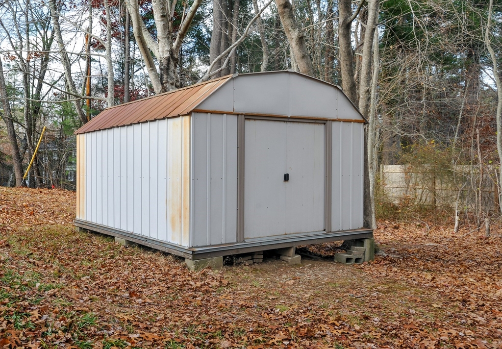 134 Crescent Street Hanson, MA 02341 - Photo 13 of 31 a backyard of a house with a small yard and wooden fence