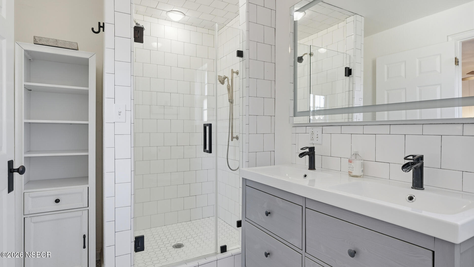 545 Perkins Street Los Alamos, CA 93440 - Photo 17 of 49 a bathroom with a shower sink and mirror
