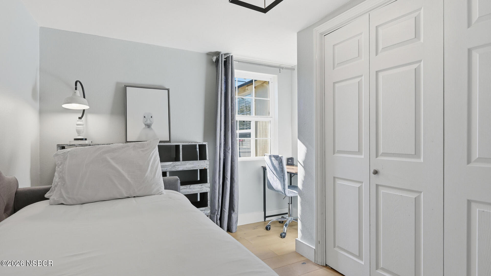 545 Perkins Street Los Alamos, CA 93440 - Photo 23 of 49 a bedroom with a bed and a chandelier