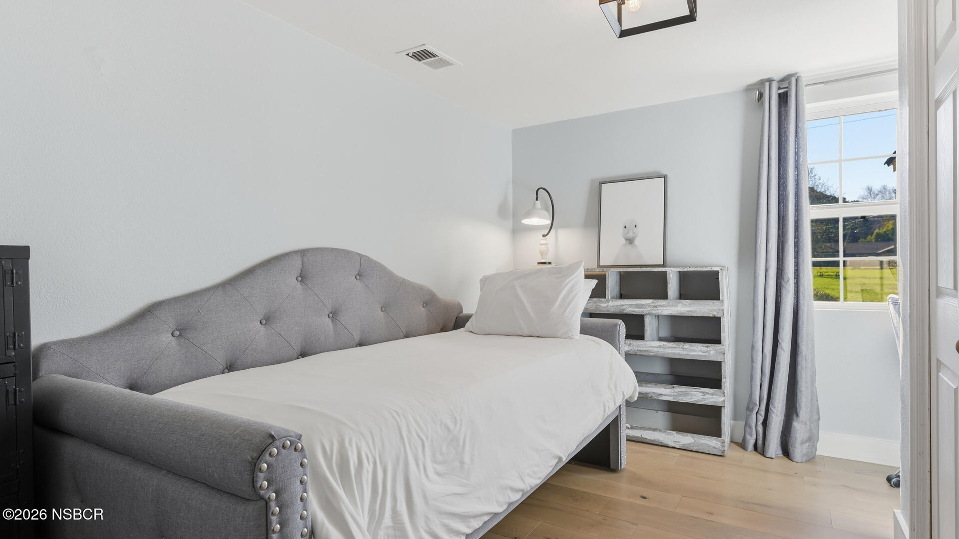 545 Perkins Street Los Alamos, CA 93440 - Photo 25 of 49 a bedroom with a bed and a cabinets