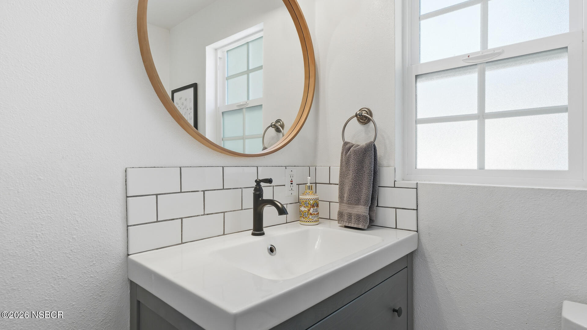 545 Perkins Street Los Alamos, CA 93440 - Photo 26 of 49 a bathroom with a sink and a mirror