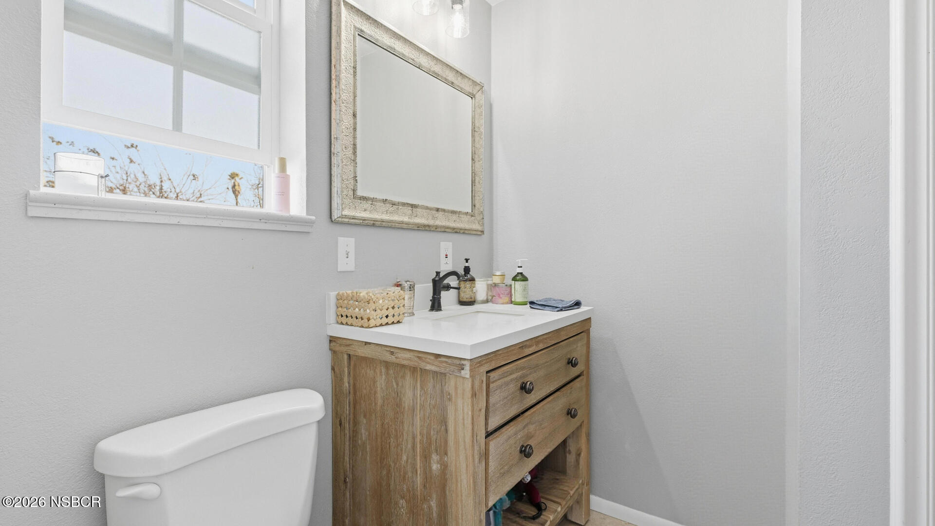 545 Perkins Street Los Alamos, CA 93440 - Photo 29 of 49 a bathroom with a granite countertop sink and a toilet