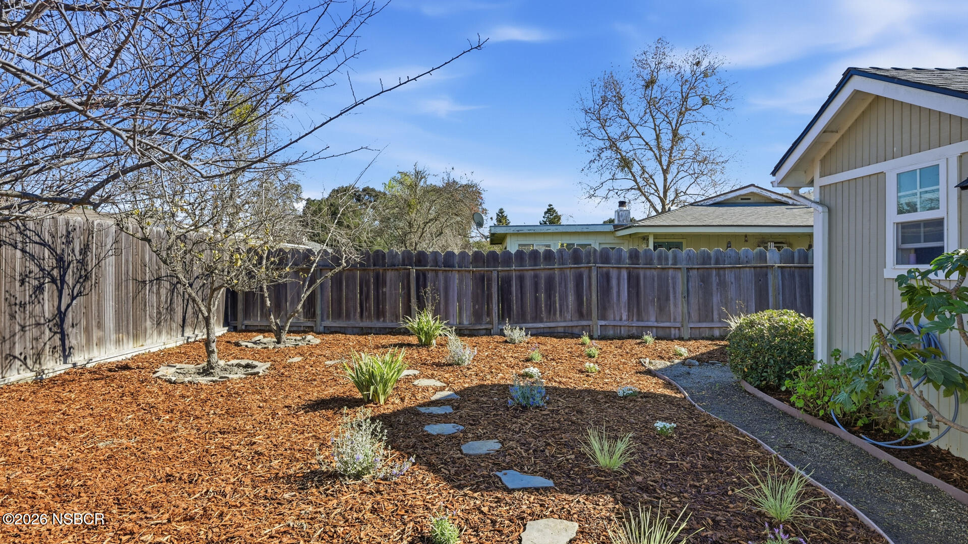 545 Perkins Street Los Alamos, CA 93440 - Photo 43 of 49 a backyard with table and chairs and wooden fence