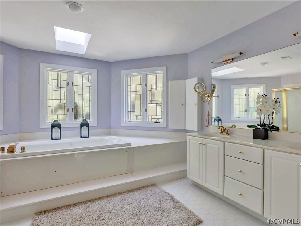 1930 Corner Rock Road Midlothian, VA 23113 - Photo 28 of 37 a bathroom with double vanity sinks and a bathtub