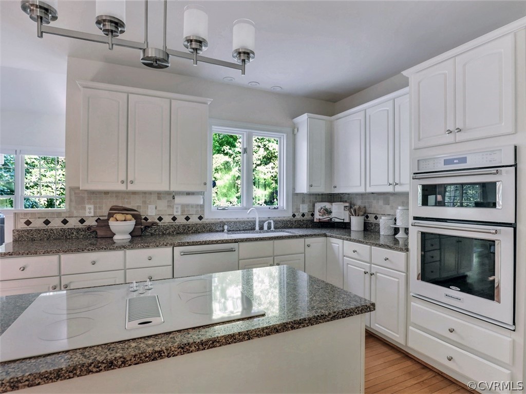 1930 Corner Rock Road Midlothian, VA 23113 - Photo 9 of 37 a kitchen with granite countertop white cabinets white appliances a sink and a potted plant