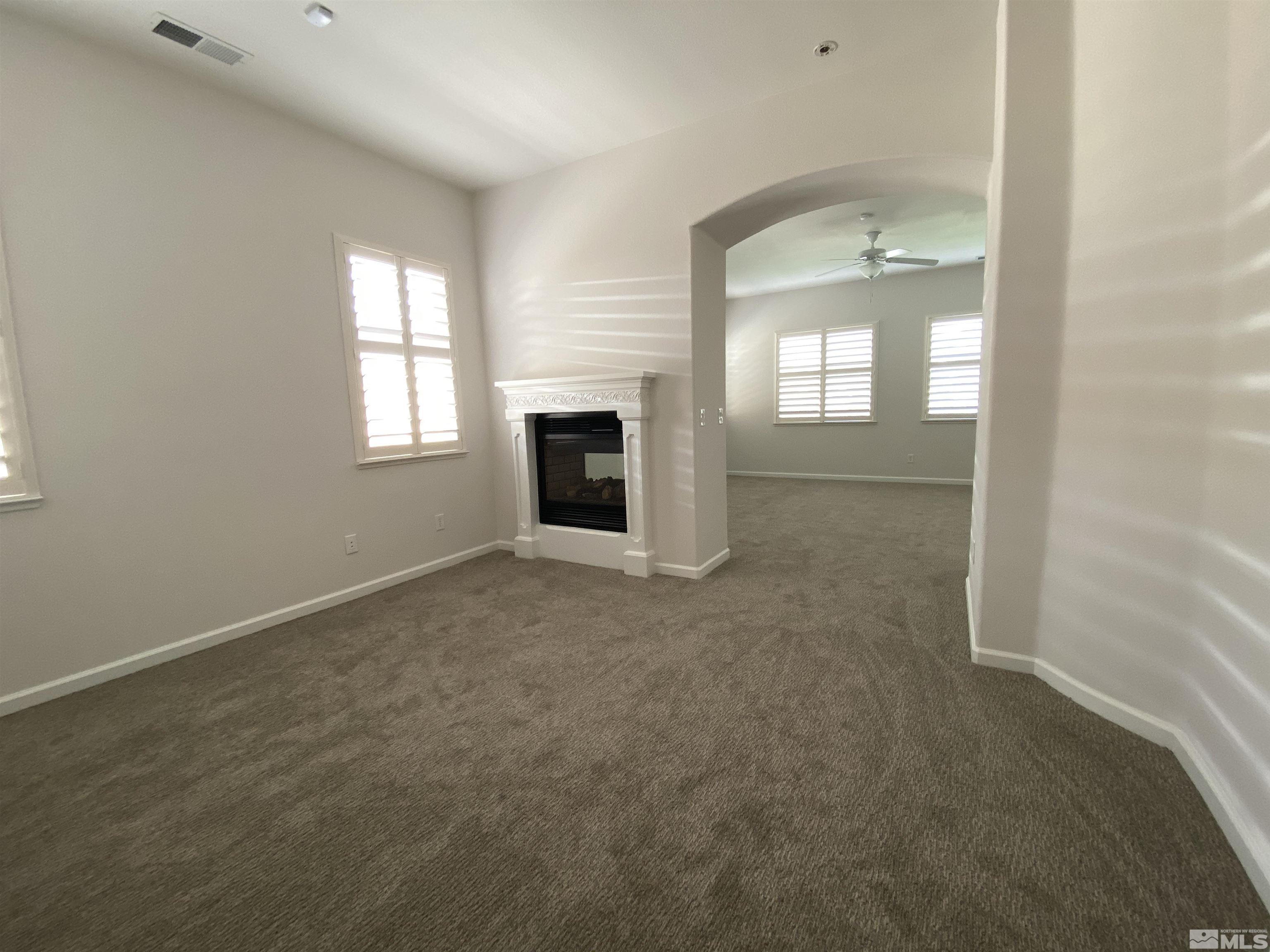 2700 Trail Rider Drive Reno, NV 89521 - Photo 19 of 29 an empty room with a fireplace and windows