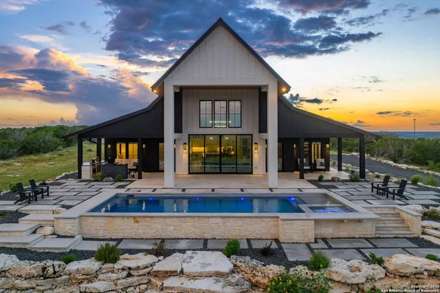 a view of a house with backyard and sitting area