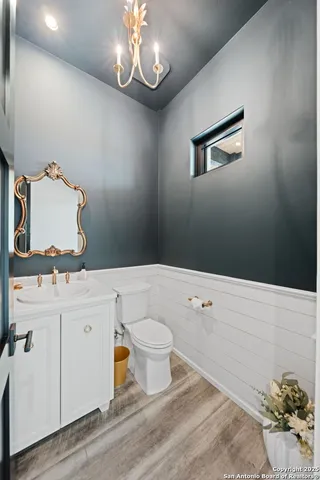 a bathroom with a sink a toilet and mirror
