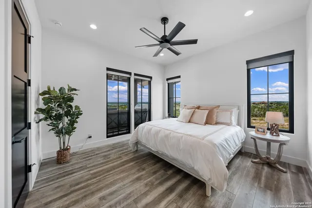 a bedroom with a large bed and a chandelier