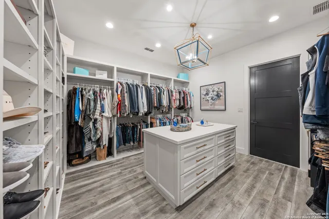 a view of a refrigerator and a view of storage and utility room