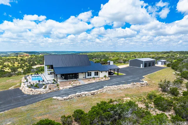 a backyard of a house with table and chairs
