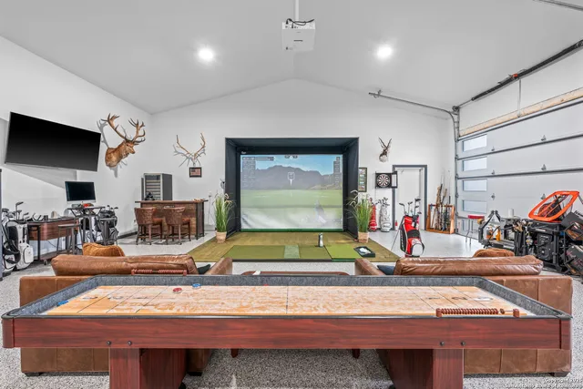 a room with furniture pool table and flat screen tv