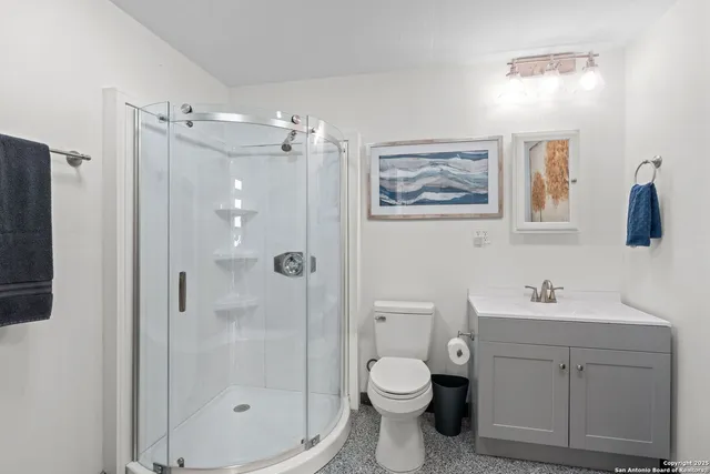 a bathroom with a toilet sink and shower