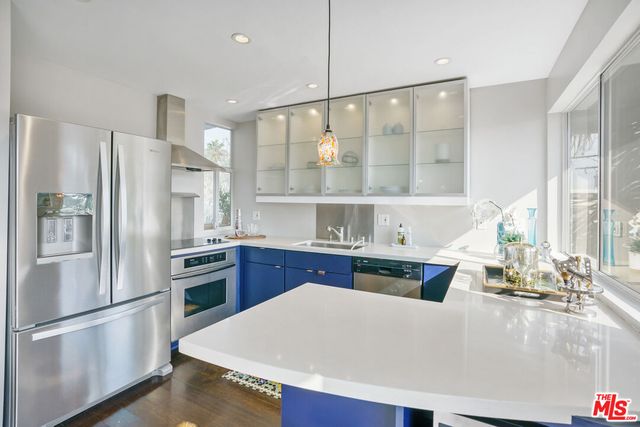 a kitchen with stainless steel appliances a refrigerator and a stove