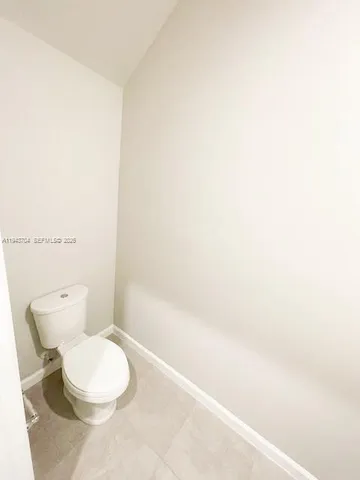 a white toilet sitting next to a white cabinet