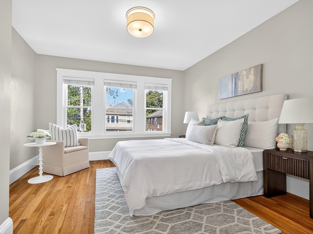 a bedroom with a large bed and a window