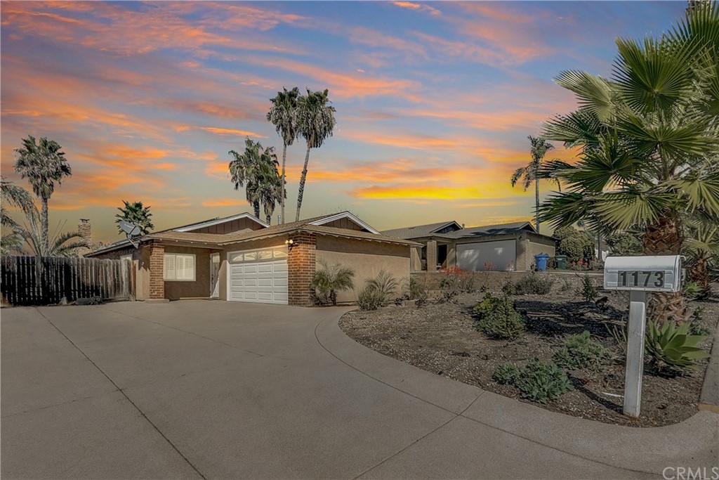 1173 Caren Road Vista, CA 92083 - Photo 1 of 1 a front view of a house with a yard and garage