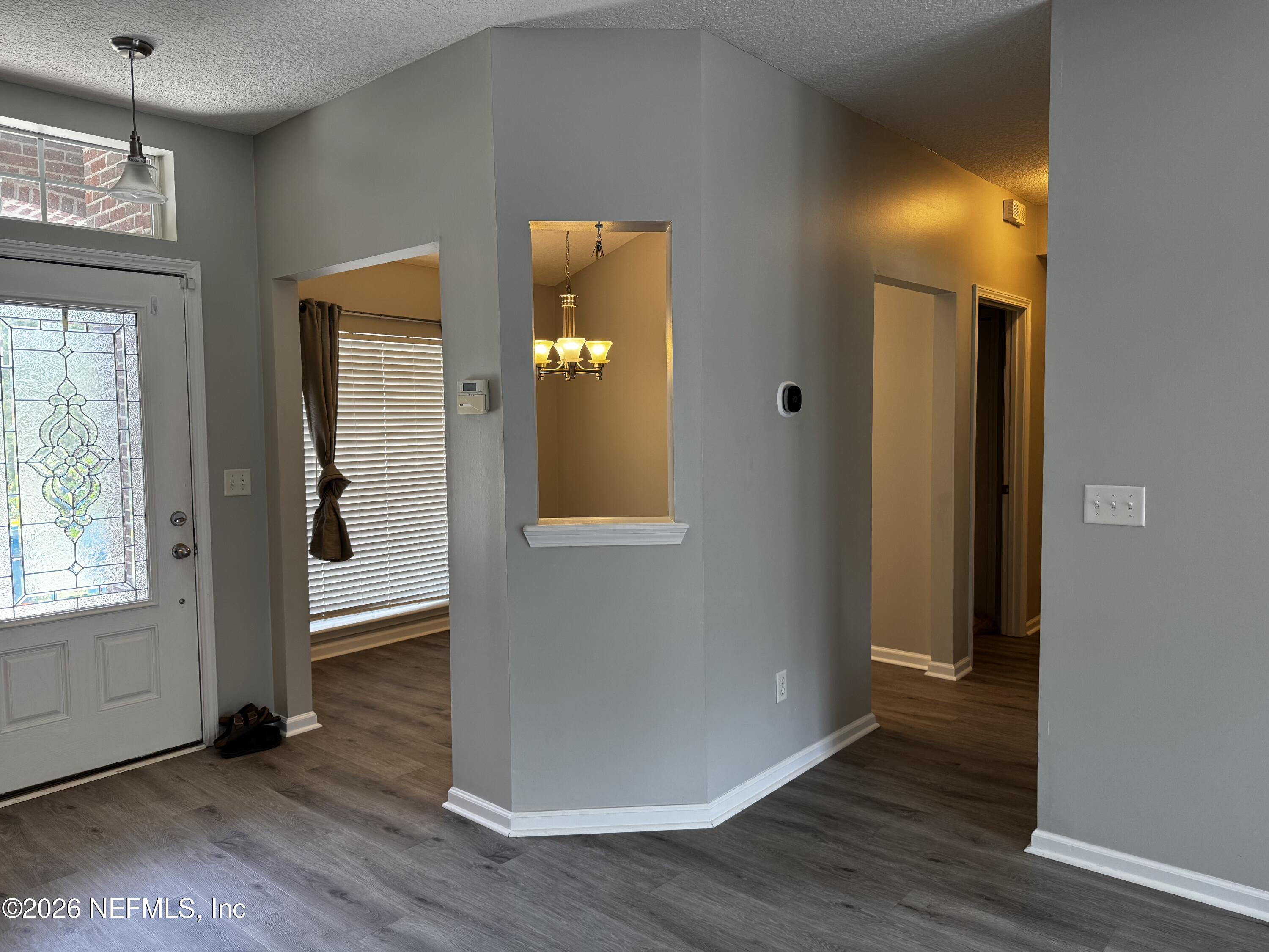 16255 Shellcracker Road Jacksonville, FL 32226 - Photo 8 of 40 an empty room with wooden floor and windows