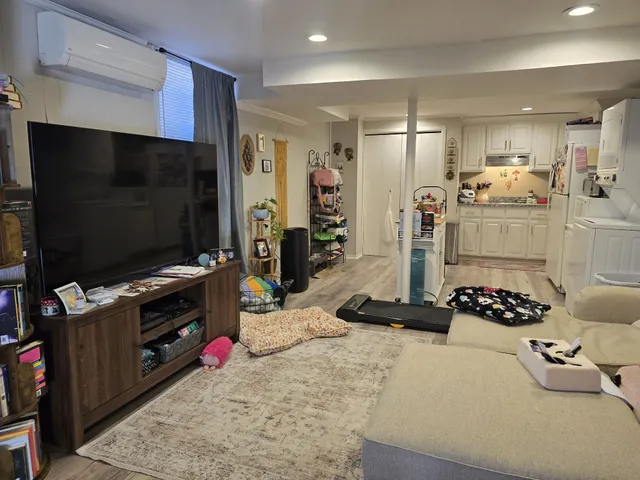 a kitchen with stainless steel appliances kitchen island granite countertop a stove refrigerator and cabinets