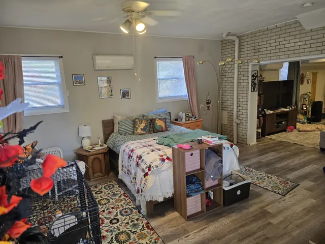 a bedroom with bed and a window